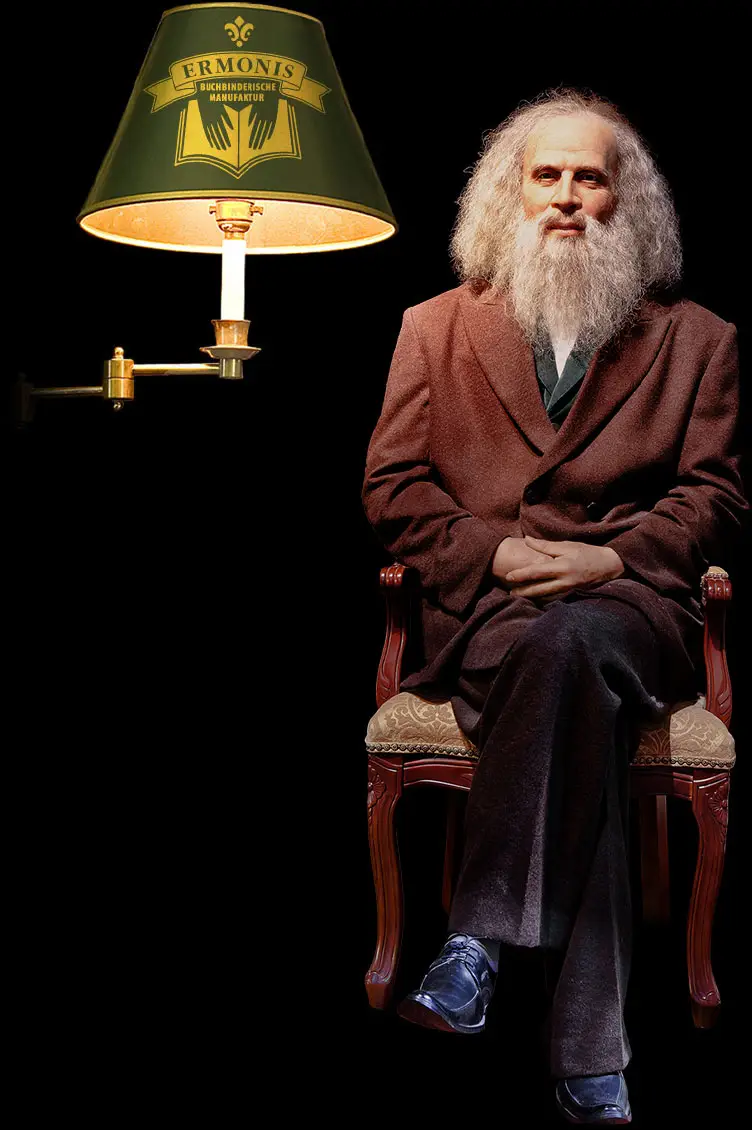 ERMONIS Markenauftritt: Lampe, Person, Laptop und Geschäftsausstattung.