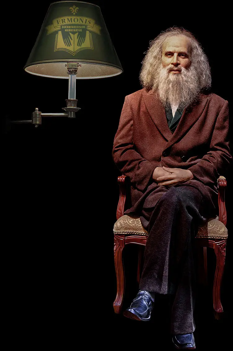 ERMONIS Markenauftritt: Lampe, Person, Laptop und Geschäftsausstattung.